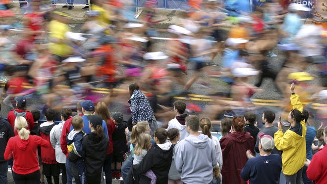 In this April 15, 2019, photo, fans cheer on the third wave of runners at the start of the 123rd Boston Marathon in Hopkinton. Due to the coronavirus pandemic, the 2020 Boston Marathon was canceled for the first time in its 124-year history. There will be a virtual event instead, where a weeklong TV special beginning Sept. 7 will showcase runners' stories as they go the distance on their own.