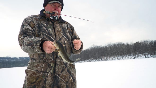 Cord Stahl of Mohegan Lake catches a bass that he released back into the lake at FDR State Park in Yorktown on Thursday. Stahl has been ice fishing for 50 years.