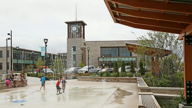 Children play on the splash pad next to the new Oak Creek City Hall and library in 2016. The city has had plenty of success attracting and keeping businesses recently by working with them.