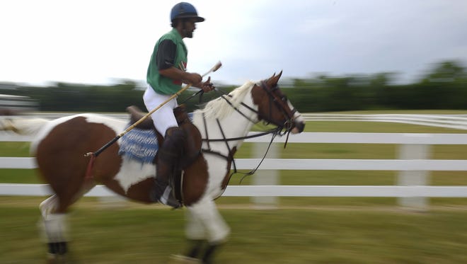 Zulu Scott-Barnes makes his way to the arena to play polo at Franklin Polo Academy at The Park at Harlinsdale Farm May 26, 2016 in Franklin, Tenn.