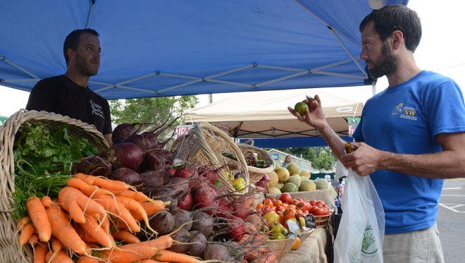 Diggin' Roots Farm sells organic vegetables at the Silverton Farmers Market in 2013.