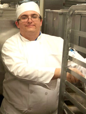 Lebanon County native Zachary A. Knol positions equipment Thursday, May 5, 2016, in the kitchen at Churchill Downs in Louisville, Ky. The Pennsylvania College of Technology junior, who is studying culinary arts and systems, joined 24 fellow students for a week of hands-on work preparing 170,000 meals for visitors to the Kentucky Derby.
