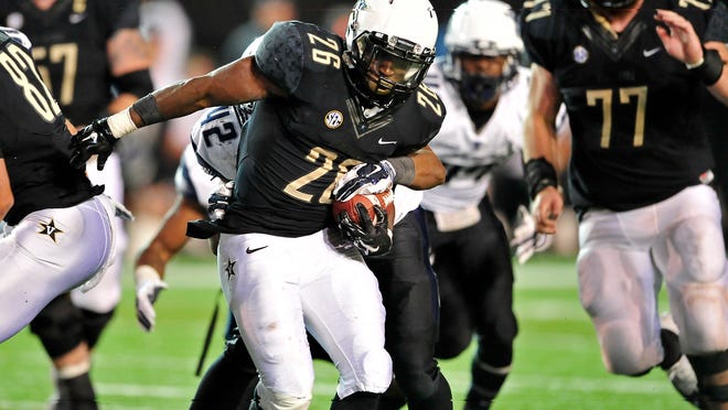
Vanderbilt running back Ralph Webb (26) is tackled by Old Dominion’s D.J. Simon during the fourth quarter Saturday. Webb had 166 yards on 31 carries in the game. 
