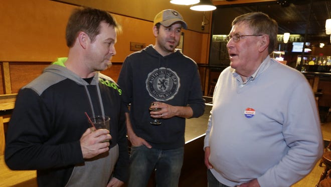 Oshkosh Mayor Steve Cummings, right, talks with Chris Clark and Ryan Homman Tuesday, April 4, 2017, at a victory celebration at Oblio's Lounge.
