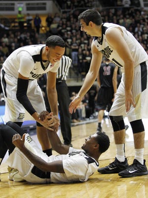 Kendall Stephens and Dakota Mathias laugh as they help Johnny Hill to his feet after he was fouled on a fast break against Northwestern Ohio on Sunday, November 8, 2015, at Mackey Arena. Purdue defeated Northwestern Ohio 92-43.