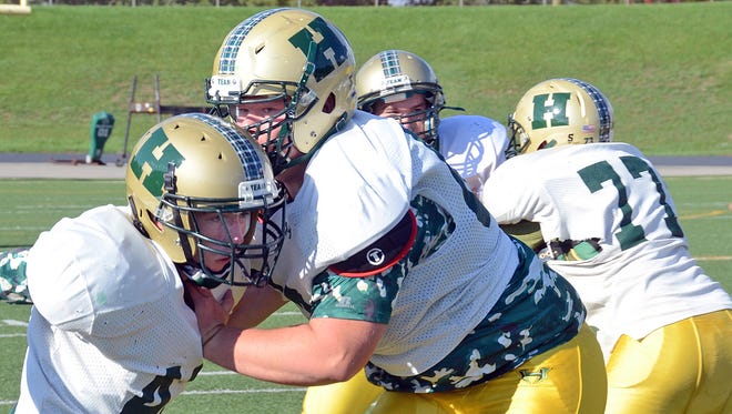 Offensive tackle Wil Manson (right), blocking linebacker Erik Ablett  at practice, is a three-year starter.