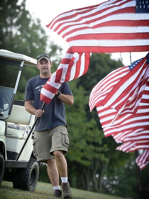 Travis Goebel secures American flags to the fence posts at the Fogleman homestead at 1536 Old Forge Road, North Londonderry Township, on Thursday, Sept. 8. The homestead is the site for Fogelman's Wounded Warrior Music Fest, set for 9 a.m. to 11 p.m. Saturday, Sept. 10, rain or shine. One hundred flags will be displayed for the festival and offered for sale, with profits donated to the Wounded Warrior organization. Live entertainment starts at 2 p.m. and includes singer Olivia Farabaugh, Shift Seven with guest singer Pam Weaver of Steel Kitty, Flamin’ Dick and the Hot Rods, Applejack, The Youngers, The Matt Creter Band, Whiskey Tree, and the Honkey Tonk Medics.