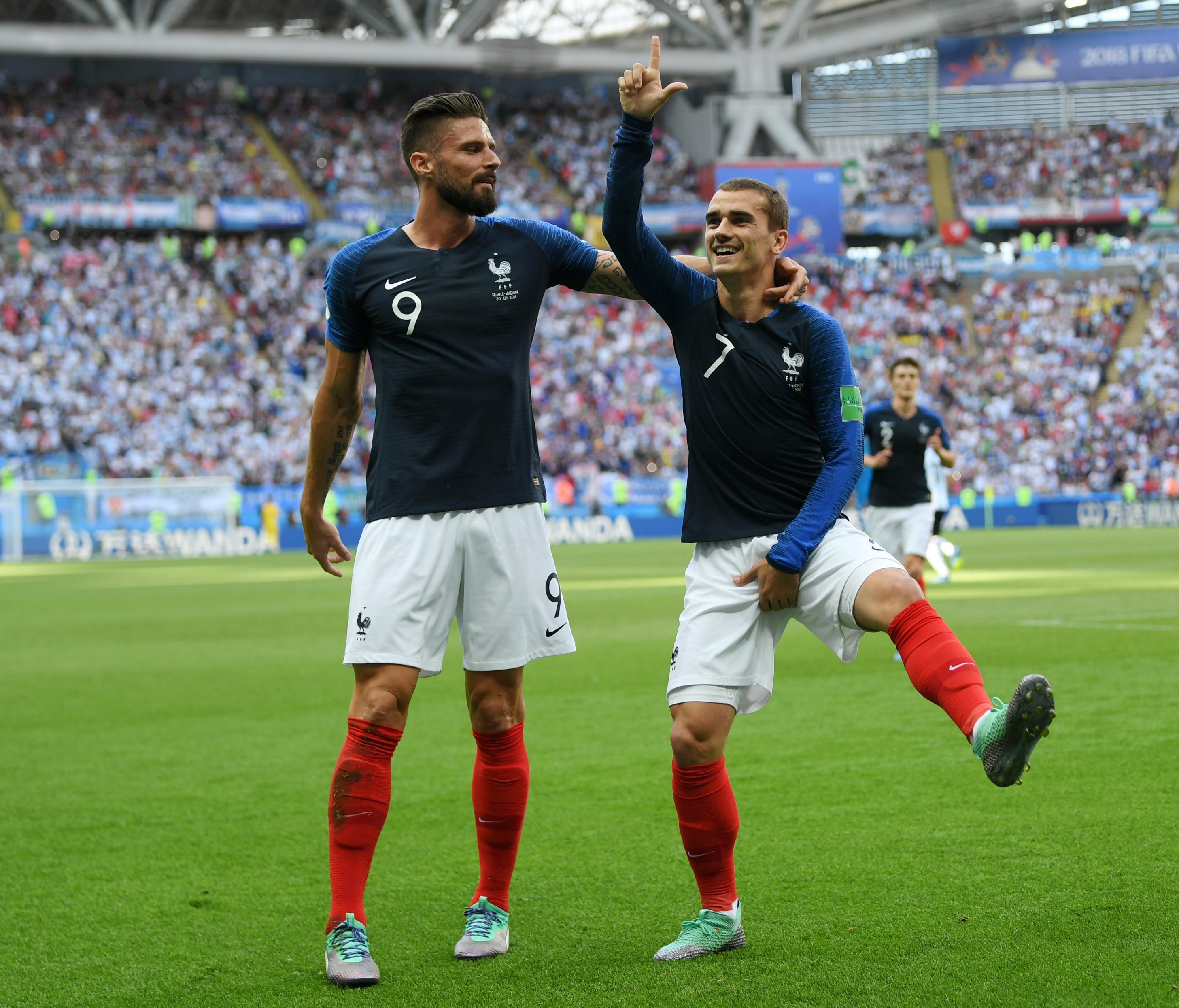 France's Antoine Griezmann celebrates with teammate Olivier Giroud after scoring his team's first goal during the 2018 FIFA World Cup Russia Round of 16 match between France and Argentina.