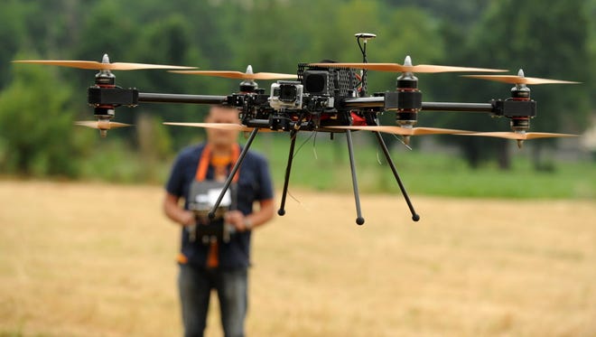 A man operates with a remote control 4-8X Dual Atex drone on June 6, 2015, in Pau, southwestern France. T