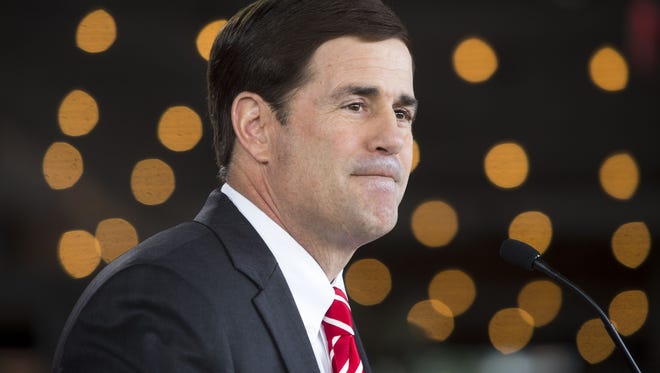 0218130520yws PNI Ducey gubernatorial kickoff 2019 - 2.19.14 - State Treasurer Doug Ducey (cq), along with his wife Angela (cq) and 10-year-old son Sam (cq), formally announces his bid as a Republican gubernatorial candidate (cq) at a restaurant in Phoenix (cq) on Wednesday, February 19, 2014 (cq). The creator of Cold Stone Creamery (cq) told an audience of around 50 supporters he wants to eliminate state income tax, revive the economy and improve education. - Charlie Leight/The Arizona Republic