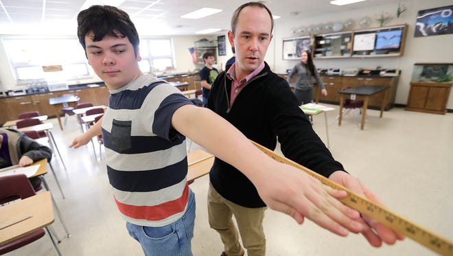 Golden Apple teacher Steve Engels works with student Brandon Grovogel on a biological parameter measuring lesson on March 16, 2017.