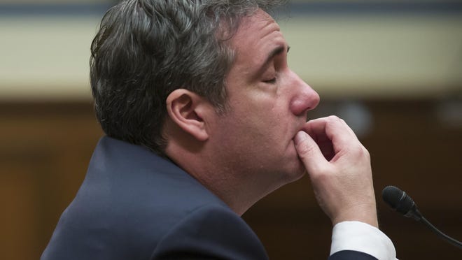Michael Cohen, President Donald Trump's former lawyer, gets emotional as he listens to closing remarks from House Oversight and Reform Committee Chair Elijah Cummings, D-Md., as he testifies before the House Oversight and Reform Committee, on Capitol Hill, Feb. 27, 2019, in Washington.