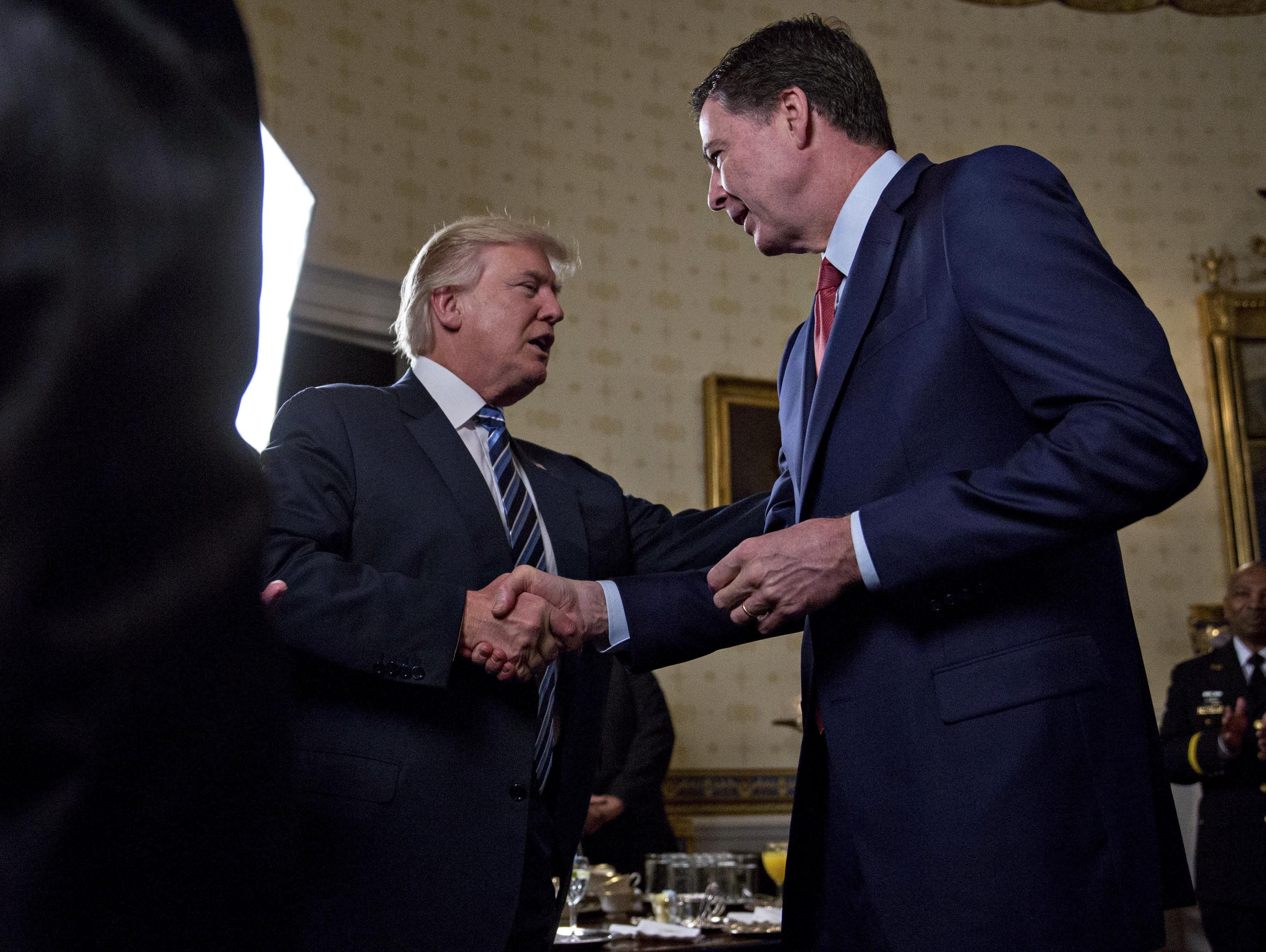 President Trump shakes hands with FBI Director James Comey during an Inaugural Law Enforcement Officers and First Responders Reception at the White House on Jan. 22, 2017.