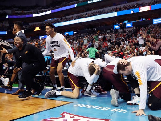 The Loyola (Il) Ramblers bench reacts during the second