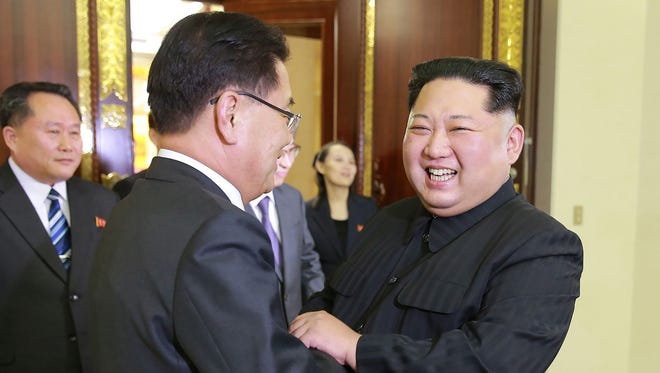 North Korean leader Kim Jong-Un, right shakes hands with South Korean chief delegator Chung Eui-yong, who travelled as envoys of the South's President Moon Jae-in, during their meeting in Pyongyang on Monday