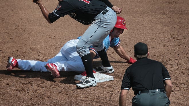 El Paso's Jose Randon waits for the call after tagging out Kevin Herget during the Redbirds game against the Chihuahuas at Autozone park Thursday afternoon. A walk-off 2-run homer in the bottom of the 11th inning delivered Memphis a 2-0 win over El Paso in Game 2 of the Pacific Coast League championship series.