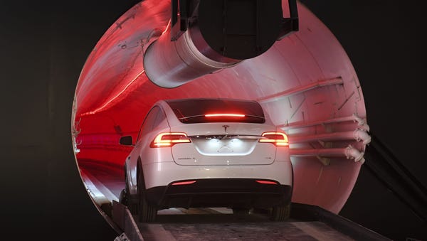 A modified Tesla Model X drives into the tunnel...