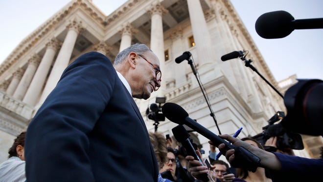 In this Friday, Jan. 19, 2018 file photo, Senate Minority Leader Chuck Schumer, D-N.Y., center, speaks to the media outside the Capitol after meeting with President Donald Trump in Washington. On Friday, Jan. 26, 2018, The Associated Press has found that stories circulating on the internet about Schumer receiving a large donation from a pro-illegal alien group before the Jan. 19 congressional vote that led to the three-day government shutdown are untrue. (AP Photo/Jacquelyn Martin)