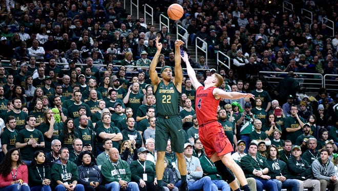 Michigan State's Miles Bridges, left, makes a 3-pointer as Maryland's Kevin Huerter defends during the first half on Thursday, Jan. 4, 2018, at the Breslin Center in East Lansing.