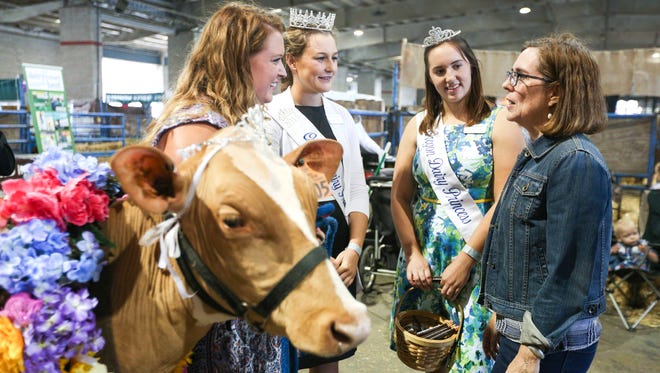 (Right to left) Gov. Kate Brown talks to Oregon Dairy Princesses Gina Atsma and Sara Pierson, and Oregon Dairy Women Director Jessica Kliewer, at the State Fair on Friday, Sept. 2, 2016, in Salem, Ore.
