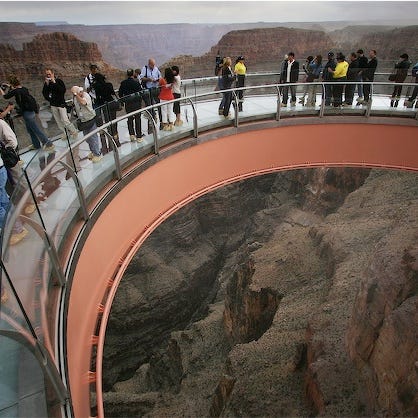 Visitors step onto the Grand Canyon Skywalk on opening day.