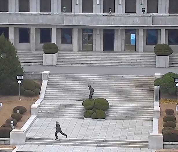 This screengrab made from video footage released by the United Nations Command on Nov. 22 shows North Korea soldiers reacting to the news of a defection.