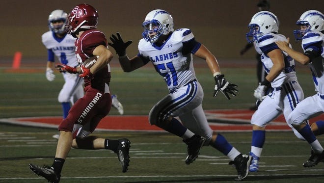 Fillmore linebacker Kevin Galvan (center) chases down Santa Paula’s Anthony Morales during their Sept. 18 rivalry game. Galvan made the All-Tri-Valley League first team.