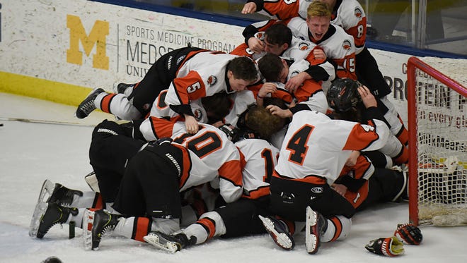 Brother Rice players celebrate after capturing the fifth state championship in program history on Saturday.