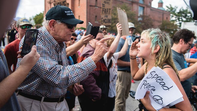 A Donald Trump supporter and a young protestor get into a heated debate outside the U.S. Cellular Center before a Trump rally on Sept. 12, 2016. Ever since the election, the left has been tarred in the United States as being hopelessly out of touch.