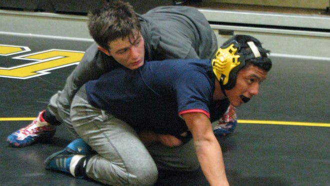 Sophomore 126-pounder Trevor Fleet (top) engages in a practice drill with West Milford teammate Brandon Sanchez Friday in preparation for the Passaic County wrestling tournament.
