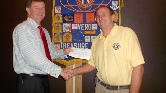 Kevin Brown (left) of Wilmington Trust presents a check to Richard Schlitt, co-director of Kiwanis Youth in Action.