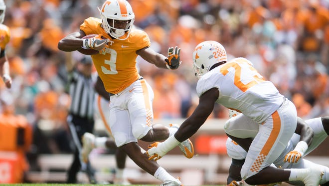 Tennessee running back Ty Chandler (3) runs the ball while defended by Tennessee linebacker Will Ignont (23) during the Tennessee Orange & White spring game at Neyland Stadium at University of Tennessee Saturday, April 21, 2018.