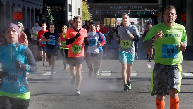 Marathoners run down Larnard street  at the 38th Annual Detroit Free Press/Talmer Bank Marathon in Detroit on Sunday, Oct. 18, 2015
