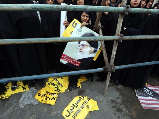 A woman protests near the former U.S. Embassy in Tehran.