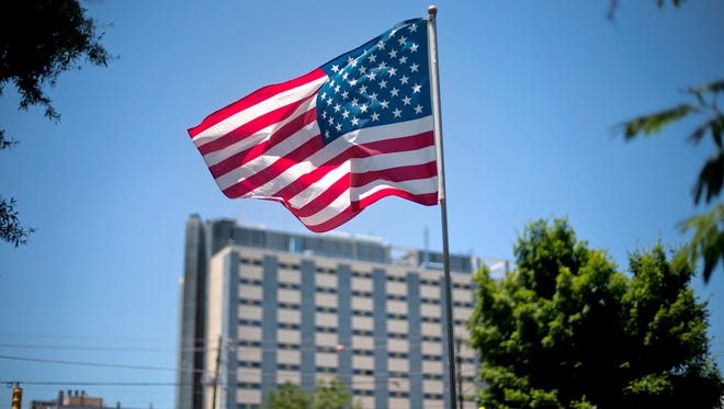 FILE - In this May 24, 2013, file photo, an American flag flies in front of the Atlanta VA Medical Center in Atlanta. After two overwhelming votes in two days, congressional lawmakers say they are confident they can agree on a bill to improve veterans’ health care and send it to the president’s desk by the end of the month.  (AP Photo/David Goldman, File)