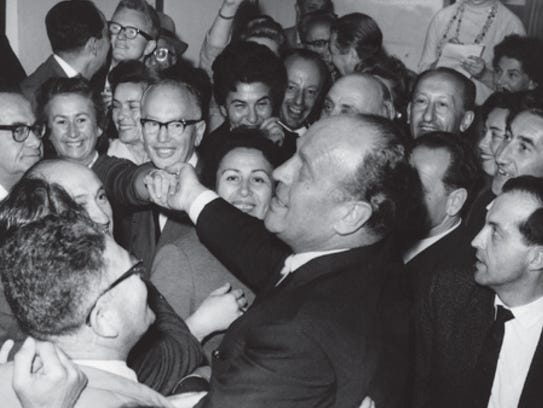 Oskar Schindler greets a crowd at the Jerusalem airport