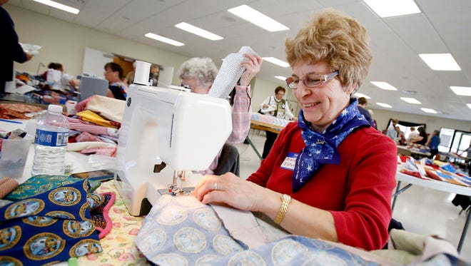Quilts of Valor member Diane Elston, of Elmira, sews an Army quilt together in a bricks and mortar design Saturday during the group's quilting marathon at the Corning American Legion. Every quilt made will end up in the hands of a veteran or active service member.