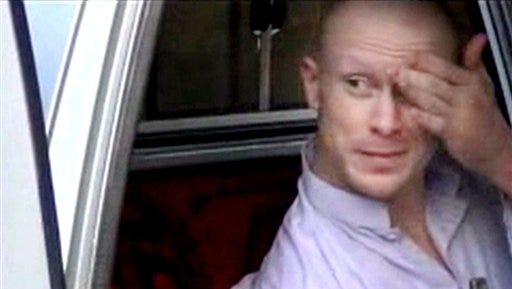 FILE - In this file image taken from video obtained from Voice Of Jihad Website, which has been authenticated based on its contents and other AP reporting, Sgt. Bowe Bergdahl, sits in a vehicle guarded by the Taliban in eastern Afghanistan. A one-year travel ban is expiring for five senior Taliban leaders held in U.S. detention at Guantanamo Bay until they were released last year in exchange for Bergdahl, who was held captive by the Taliban for nearly five years after he walked away from his Army post in Afghanistan. (AP Photo/Voice Of Jihad Website via AP video, File)