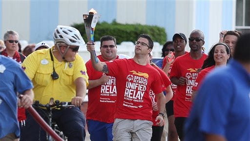 Michael Glantz, with Bank of America Corp., runs with the "Flame of Hope" Torch during the Special Olympics Unified Relay Across America behind Disney's BoardWalk Inn  on May 27, 2015 in Orlando, Fla.  The Special Olympics "Flame of Hope" Torch is making its historic trip across America, on its way to the 2015 Special Olympics World Games in Los Angeles.