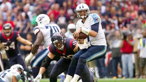 Houston Texans defensive end J.J. Watt (99) sacks Tennessee Titans quarterback Zach Mettenberger during an NFL football game Sunday, Nov. 30, 2014, in Houston. (AP Photo/Conroe Courier, Jason Fochtman)