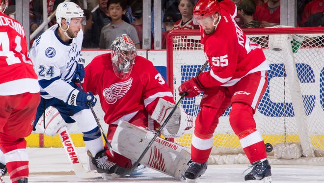 Tampa Bay right wing Ryan Callahan tries to get the puck past Detroit goalie Petr Mrazek and Niklas Kronwall in the second period.             The Wings won 4-0 Saturday.