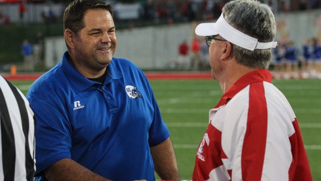 Simon Kenton head coach Jeff Marksberry shakes hands with Beechwood head coach Noel Rash prior to their game at Beechwood, Friday, September 29, 2017.