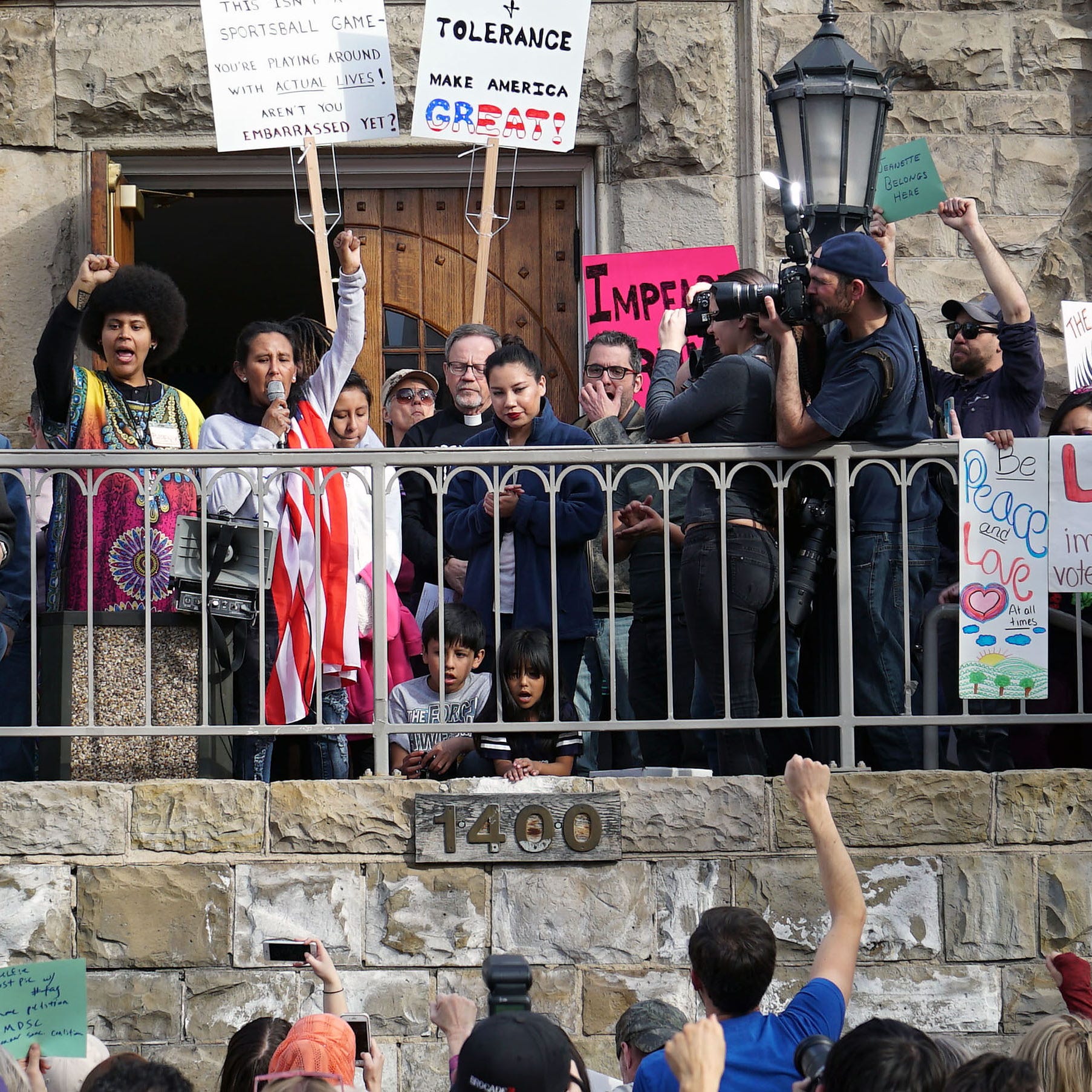 Draped in an American flag, Jeanette Vizguerra raises her fist during a rally in support of her decision to take sanctuary inside a Denver church. Vizguerra faces deportation back to Mexico because she lacks immigration permission to live in the United States.
