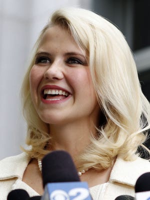 Kidnapping survivor Elizabeth Smart is shown talking to the media in front of the Frank E. Moss Federal Courthouse in Salt Lake City on May 25, 2011.  Smart who was kidnapped, raped and held captive at age 14 by a Salt Lake City street preacher is taking a job as a commentator for ABC News.
