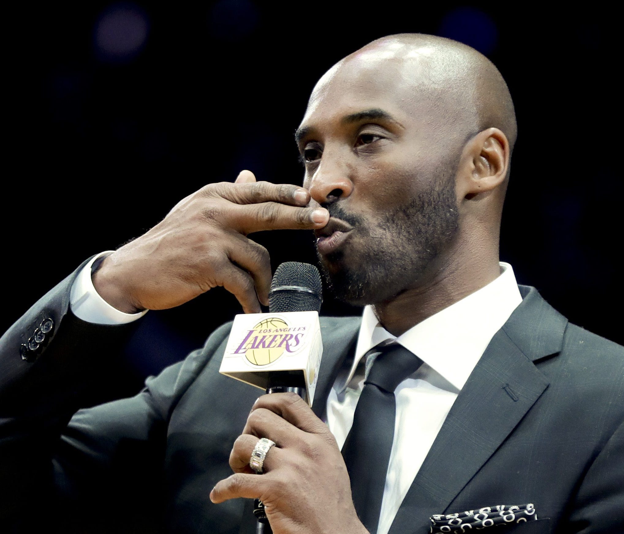 Former Los Angeles Laker Kobe Bryant speaks during a halftime ceremony retiring both of his jersey's during an NBA basketball game between the Los Angeles Lakers and the Golden State Warriors in Los Angeles, Monday, Dec. 18, 2017. (AP Photo/Chris Car