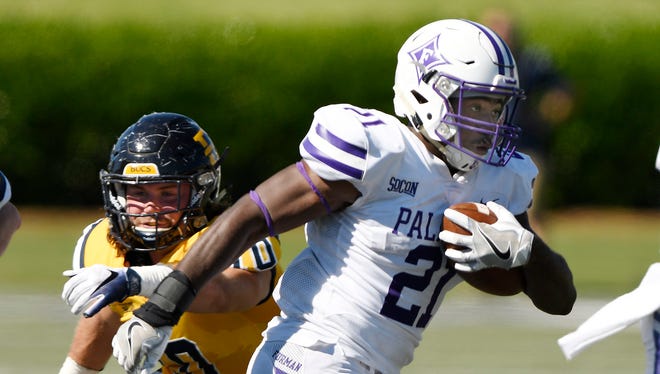 Furman’s Kealand Dirks (21) takes off on a 32 yard run against East Tennessee State.