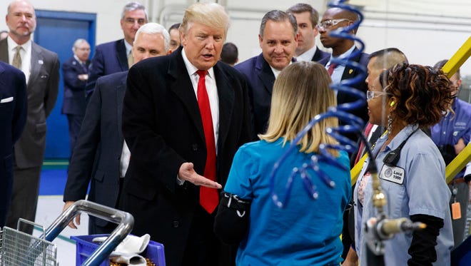 In this Dec. 1, 2016, file photo, President-elect Donald Trump greets workers during a visit to the Carrier Corp. factory in Indianapolis.