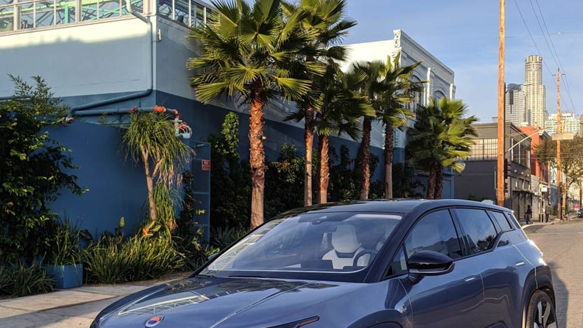 A Fisker Ocean SUV on a street near palm trees