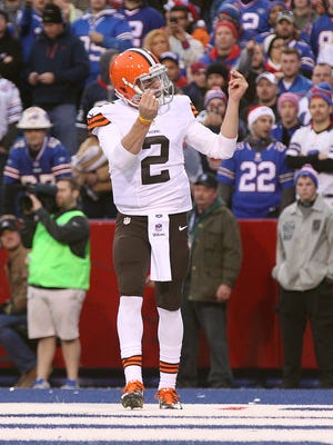Browns QB Johnny Manziel flashes his money sign after his 10-yard touchdown run.
