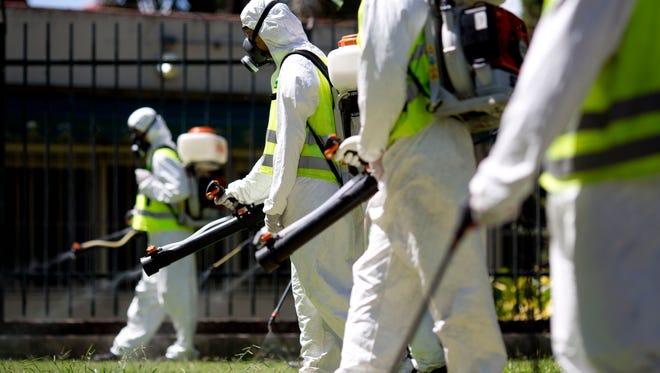 A fumigation brigade sprays an area of Chacabuco Park in a Aedes mosquito control effort, in Buenos Aires, Argentina, Wednesday, Jan. 27, 2016.